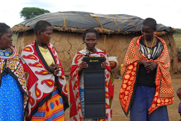 rural_african_villagers_holding_portable_solar_charger